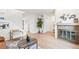 Living room with fireplace, wood floors, staircase, and neutral decor at 10311 E Evans Ave # 132, Aurora, CO 80247