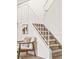 Inviting staircase featuring carpeted steps, white railing, and natural light in a neutral color palette at 10311 E Evans Ave # 132, Aurora, CO 80247