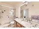 Bright bathroom featuring a glass enclosed shower and granite vanity at 2855 Blue Sky Cir # 3-102, Erie, CO 80516