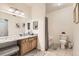 Well-lit bathroom features a tub and shower, framed mirror, granite countertop, and decorative tile flooring at 2855 Blue Sky Cir # 3-102, Erie, CO 80516