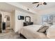 Spacious bedroom featuring a ceiling fan, access to balcony, and gray carpet at 2855 Blue Sky Cir # 3-102, Erie, CO 80516
