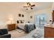 Comfortable bedroom featuring a ceiling fan, sliding glass doors to balcony, and neutral carpet at 2855 Blue Sky Cir # 3-102, Erie, CO 80516