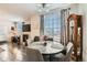 Cozy dining area with a round table, fireplace, wood floors and natural light at 2855 Blue Sky Cir # 3-102, Erie, CO 80516