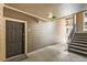 Hallway entrance with exterior door, wood paneled walls, and stairway to upper floors at 2855 Blue Sky Cir # 3-102, Erie, CO 80516