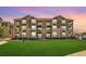 Condominium building with a well-maintained lawn and attractive facade with balconies at 2855 Blue Sky Cir # 3-102, Erie, CO 80516