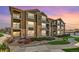 Beautiful condominium featuring a stone and siding exterior, balconies, and manicured landscaping at 2855 Blue Sky Cir # 3-102, Erie, CO 80516