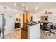 Open kitchen featuring granite counters and wood cabinets adjoining a carpeted living room at 2855 Blue Sky Cir # 3-102, Erie, CO 80516