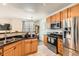 Efficient kitchen with stainless steel appliances, wood cabinets, and a breakfast bar at 2855 Blue Sky Cir # 3-102, Erie, CO 80516