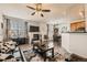 Spacious living area with a fireplace, ceiling fan, and open view to the dining area at 2855 Blue Sky Cir # 3-102, Erie, CO 80516