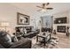 Comfortable living room with plush leather seating, fireplace, ceiling fan, and decorative rug at 2855 Blue Sky Cir # 3-102, Erie, CO 80516