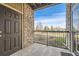 Private patio showcasing brick pillars, a black metal fence, and a scenic neighborhood view at 2855 Blue Sky Cir # 3-102, Erie, CO 80516
