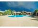 Community pool area with large pool, sun deck, and lounge chairs surrounded by lush greenery at 2855 Blue Sky Cir # 3-102, Erie, CO 80516