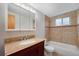 Bathroom featuring a wooden vanity, a large mirror, and a tiled shower and bathtub combo at 1144 N Ogden St # 304, Denver, CO 80218