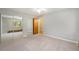 Bedroom featuring neutral carpeting, a ceiling fan and mirrored closet doors at 1144 N Ogden St # 304, Denver, CO 80218