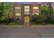 Exterior view of building with brick facade, large windows, and landscaped entryway at 1144 N Ogden St # 304, Denver, CO 80218