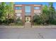 Exterior view of building with brick facade, large windows, and landscaped entryway at 1144 N Ogden St # 304, Denver, CO 80218