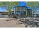 Commercial building featuring modern glass facade, bike rack, and ample parking at 1144 N Ogden St # 304, Denver, CO 80218