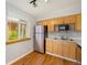 Well-equipped kitchen with stainless steel refrigerator and light wood cabinetry at 1144 N Ogden St # 304, Denver, CO 80218