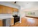 Kitchen features stainless steel appliances and adjacent living area at 1144 N Ogden St # 304, Denver, CO 80218