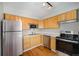 Modern kitchen with stainless steel appliances, light wood cabinets and white countertops at 1144 N Ogden St # 304, Denver, CO 80218