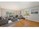 Bright living room featuring hardwood floors and large windows offering natural light at 1144 N Ogden St # 304, Denver, CO 80218