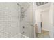 White tiled shower with shelf and tub at 551 N Pearl St # 301, Denver, CO 80203