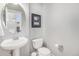 Powder room features pedestal sink, modern fixtures and soothing paint at 11687 Newton St, Westminster, CO 80031