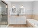 Modern bathroom with double vanity, large soaking tub, and glass-enclosed shower at 11687 Newton St, Westminster, CO 80031