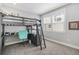 Bedroom featuring a gray loft bed with built-in desk and ladder, complemented by a window offering natural light at 11687 Newton St, Westminster, CO 80031