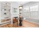 Charming breakfast nook with built-in shelving, a fireplace, and a round table with modern chairs at 11687 Newton St, Westminster, CO 80031