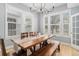 Bright dining room with natural wood table, bench and chairs, filled with natural light at 11687 Newton St, Westminster, CO 80031