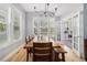 Sunlit dining room features hardwood floors, large windows, and stylish lighting at 11687 Newton St, Westminster, CO 80031
