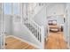 Bright foyer with hardwood floors, a staircase with white railings, and views into the living room at 11687 Newton St, Westminster, CO 80031