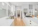 Spacious kitchen featuring an island with a breakfast bar, stainless steel appliances, and white cabinetry at 11687 Newton St, Westminster, CO 80031