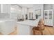 Modern kitchen with white cabinetry, stainless steel appliances, and a breakfast bar at 11687 Newton St, Westminster, CO 80031