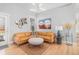 Stylish living room with modern lighting, a leather sectional sofa, and hardwood floors at 11687 Newton St, Westminster, CO 80031
