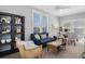 Inviting living room featuring a comfortable blue sofa, stylish decor, and plenty of natural light at 11687 Newton St, Westminster, CO 80031