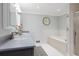 Bright bathroom with dual sinks, a soaking tub, and modern fixtures at 5643 S Fulton Way, Greenwood Village, CO 80111