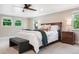 Comfortable bedroom featuring a ceiling fan, large windows, and stylish furnishings at 5643 S Fulton Way, Greenwood Village, CO 80111