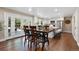 Open concept dining area with french doors to outdoor patio and kitchen island seating at 5643 S Fulton Way, Greenwood Village, CO 80111