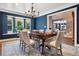 Dining room features chandelier, wood table, neutral upholstered chairs and natural light at 5643 S Fulton Way, Greenwood Village, CO 80111
