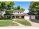 Charming two-story home with mature trees, well-manicured lawn, and covered front porch at 5643 S Fulton Way, Greenwood Village, CO 80111