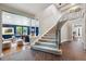 Spacious entryway featuring staircase, tiled floors, and living room at 5643 S Fulton Way, Greenwood Village, CO 80111