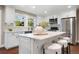 Modern kitchen with white cabinets, stainless steel appliances, and a large island at 5643 S Fulton Way, Greenwood Village, CO 80111