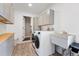 Bright laundry room with white washer and dryer, ample cabinet space, and utility sink at 5643 S Fulton Way, Greenwood Village, CO 80111
