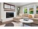 Living room with fireplace, comfortable seating, large windows and hardwood floors at 5643 S Fulton Way, Greenwood Village, CO 80111