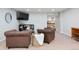 Cozy living room featuring leather armchairs, TV, and a view into a storage area at 5643 S Fulton Way, Greenwood Village, CO 80111