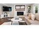Living room with fireplace, tv, comfortable seating and hardwood floors at 5643 S Fulton Way, Greenwood Village, CO 80111
