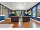 Bright living room featuring hardwood floors, dark blue walls, and comfortable seating at 5643 S Fulton Way, Greenwood Village, CO 80111