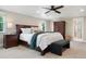 Spacious primary bedroom with a ceiling fan, large windows, and a cozy sitting area at 5643 S Fulton Way, Greenwood Village, CO 80111